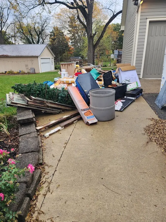 Dumpster being loaded with debris for Estate Cleanout Dumpster Rental in College Park